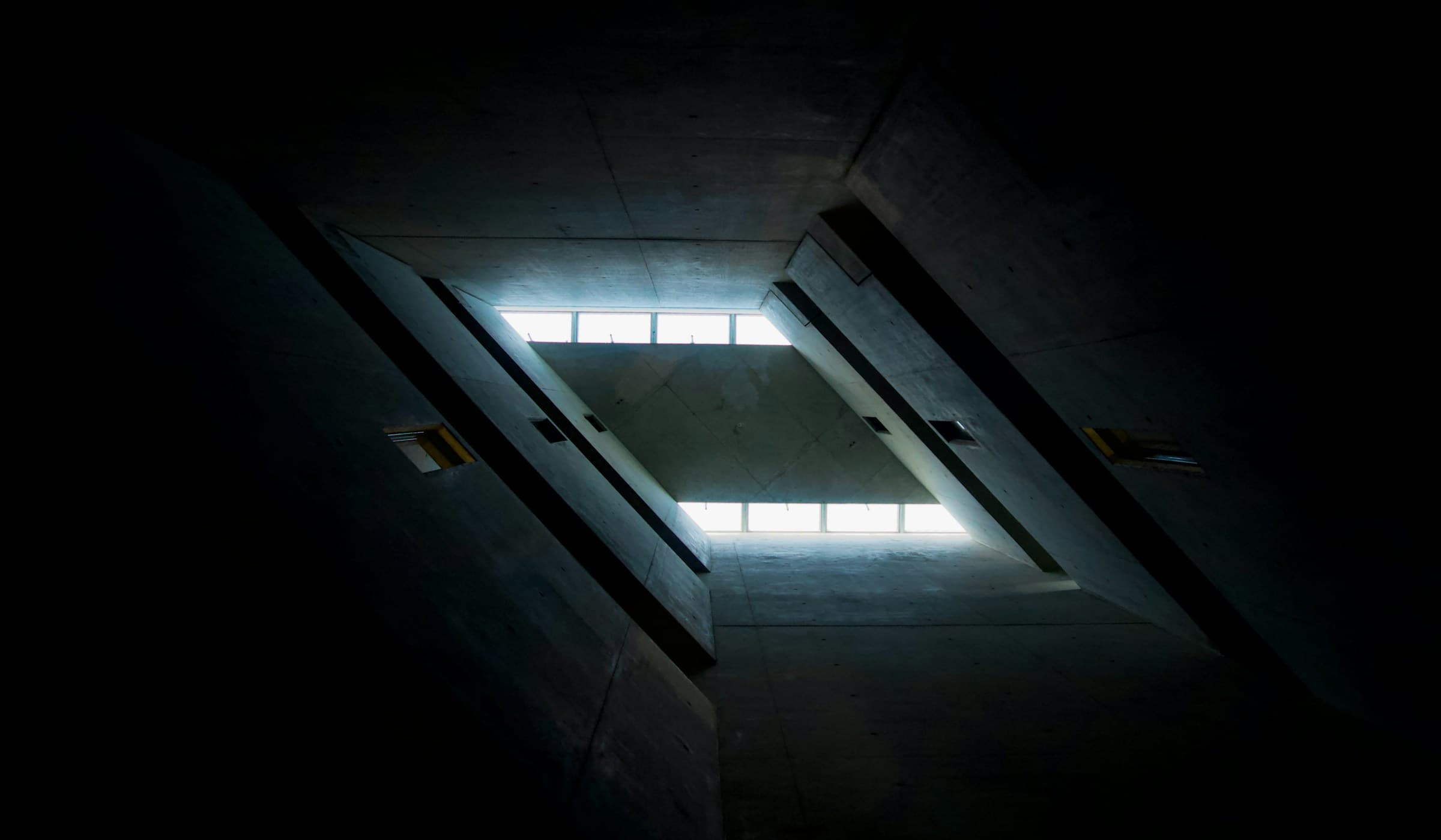 Light falling through an opening in a dark concrete structure.